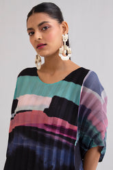 Woman in black, wide-leg pleated co-ord, front view